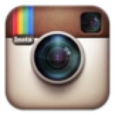 A square icon resembling a vintage camera with a rainbow stripe in the top left corner and a lens in the center.